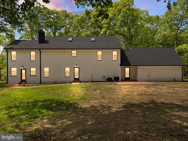  - back of house featuring a yard, entry steps, cooling unit, and a chimney