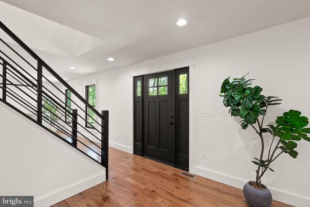  - foyer featuring stairway, wood finished floors, baseboards, and recessed lighting