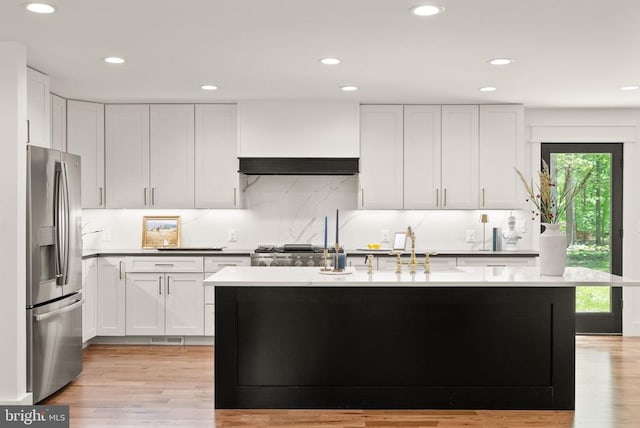  - kitchen featuring white cabinetry, light wood-style flooring, recessed lighting, and stainless steel refrigerator with ice dispenser