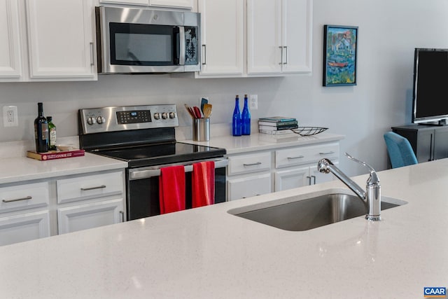 802 Wesley Ln Unit B, Charlottesville, VA 22911 - kitchen with appliances with stainless steel finishes, white cabinets, and light stone counters