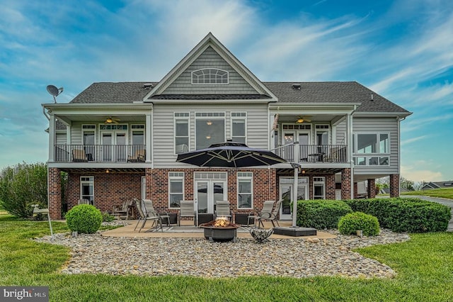 79 Carrie Ct, Mineral, VA 23117 - rear view of house featuring a balcony, an outdoor fire pit, a patio, and brick siding