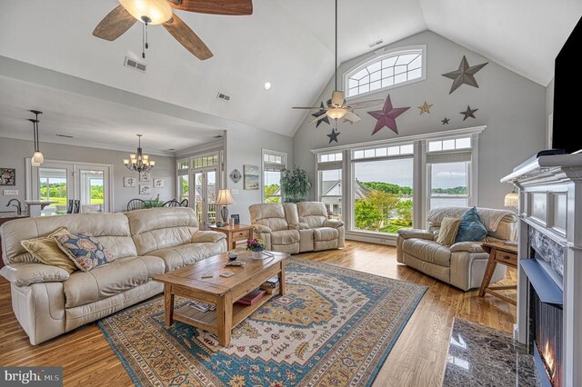 79 Carrie Ct, Mineral, VA 23117 - living room with ceiling fan, a fireplace with flush hearth, a chandelier, wood finished floors, and high vaulted ceiling