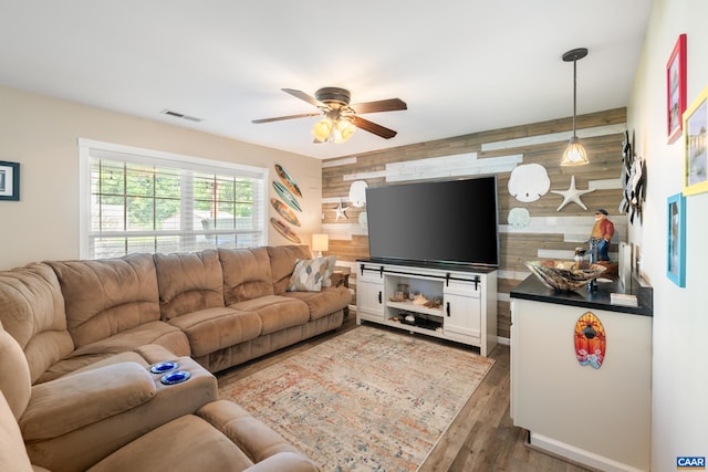 353 Bayberry Way, Charlottesville, VA 22911 - living area featuring an accent wall, wooden walls, ceiling fan, and wood finished floors