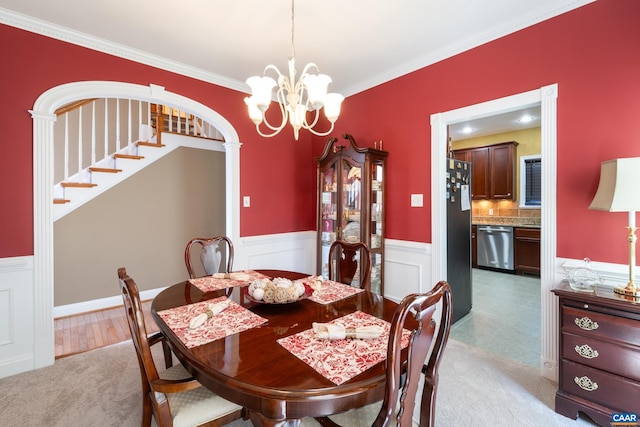 353 Bayberry Way, Charlottesville, VA 22911 - dining room with a chandelier, a wainscoted wall, crown molding, stairway, and arched walkways