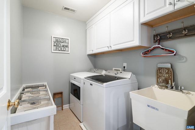 353 Bayberry Way, Charlottesville, VA 22911 - laundry area featuring separate washer and dryer, cabinet space, and light tile patterned floors