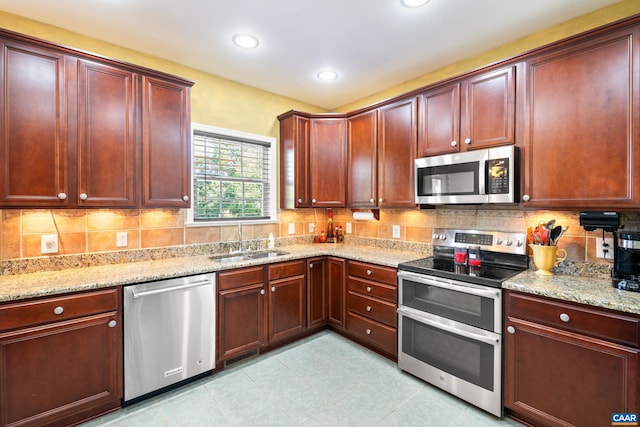 353 Bayberry Way, Charlottesville, VA 22911 - kitchen featuring appliances with stainless steel finishes, light stone counters, dark brown cabinets, and recessed lighting