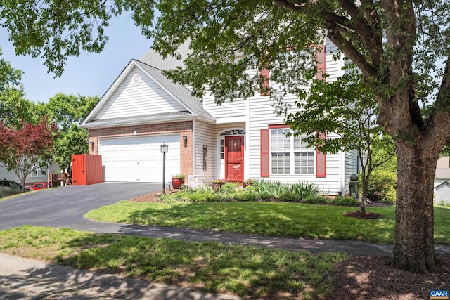 353 Bayberry Way, Charlottesville, VA 22911 - view of front of home with asphalt driveway, an attached garage, a front yard, brick siding, and roof with shingles