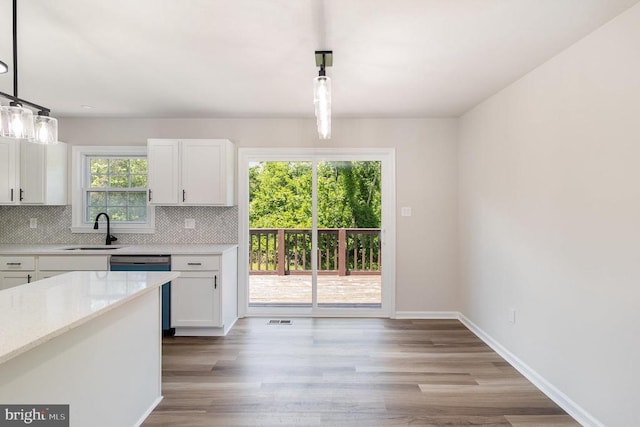 8452 Turnbull Rd, Warrenton, VA 20186 - kitchen featuring a sink, tasteful backsplash, white cabinetry, and wood finished floors