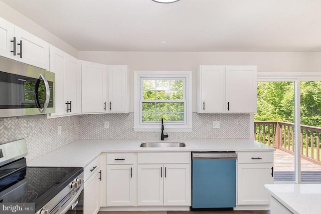 8452 Turnbull Rd, Warrenton, VA 20186 - kitchen with stainless steel appliances, a sink, white cabinetry, and tasteful backsplash