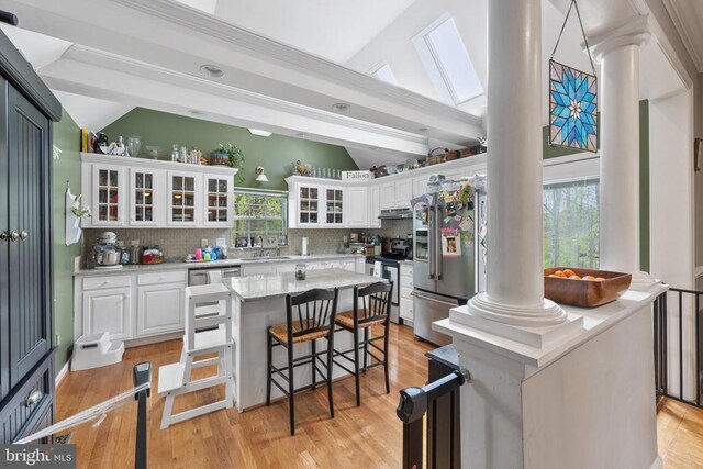 372 Daniels Rd, Barboursville, VA 22923 - kitchen with decorative columns, stainless steel appliances, lofted ceiling, decorative backsplash, and a sink