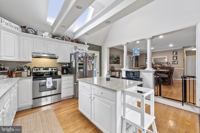 372 Daniels Rd, Barboursville, VA 22923 - kitchen featuring stainless steel appliances, under cabinet range hood, ornate columns, vaulted ceiling, and tasteful backsplash