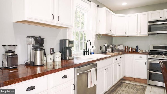 43 Briar Patch Ln, Boston, VA 22713 - kitchen with stainless steel appliances, a sink, white cabinets, dark countertops, and light tile patterned floors