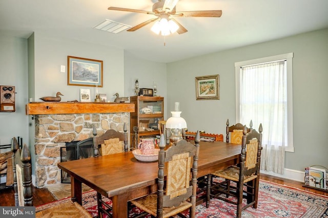 43 Briar Patch Ln, Boston, VA 22713 - dining room featuring a stone fireplace, ceiling fan, healthy amount of natural light, and wood finished floors