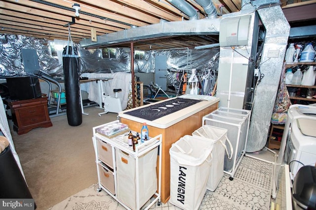 unfinished basement featuring washer and clothes dryer and electric panel