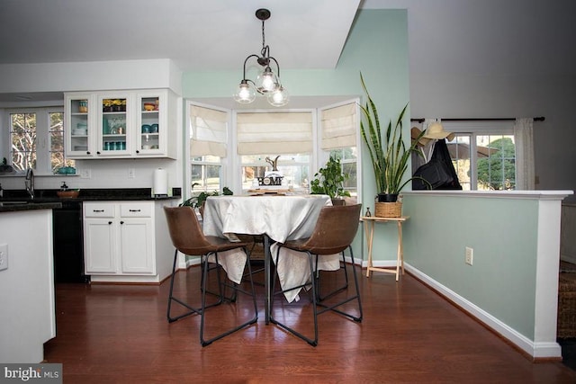 dining area with dark wood-style floors and baseboards