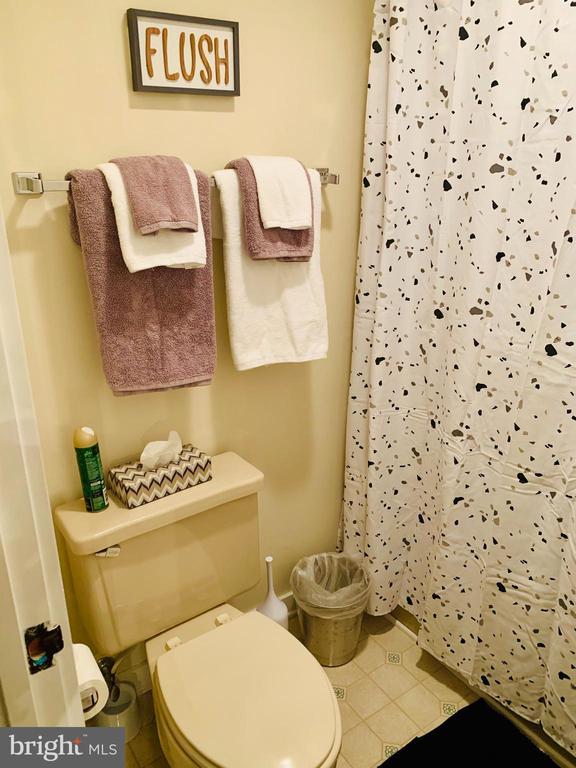 1421 Highlands, Roseland, VA 22967 - bathroom with toilet, a shower with curtain, and tile patterned flooring