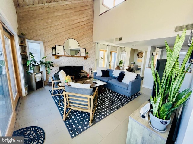 1421 Highlands, Roseland, VA 22967 - tiled living room featuring high vaulted ceiling, wooden walls, plenty of natural light, and wood ceiling