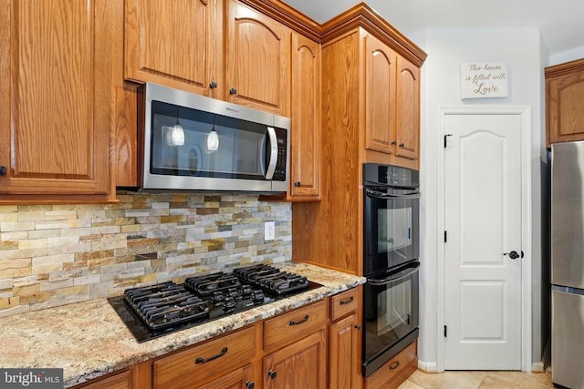 641 Keswick Dr, Culpeper, VA 22701 - kitchen featuring black appliances, light stone counters, tasteful backsplash, and brown cabinetry