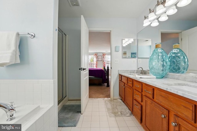 641 Keswick Dr, Culpeper, VA 22701 - ensuite bathroom with double vanity, a bath, a stall shower, and tile patterned flooring