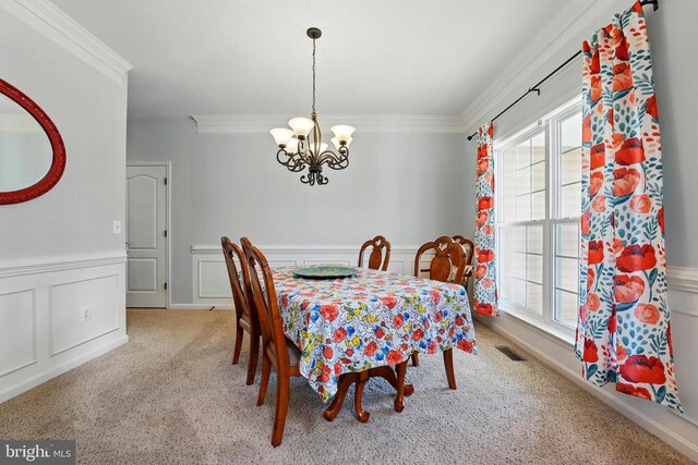 641 Keswick Dr, Culpeper, VA 22701 - carpeted dining space featuring a chandelier, plenty of natural light, ornamental molding, wainscoting, and a decorative wall