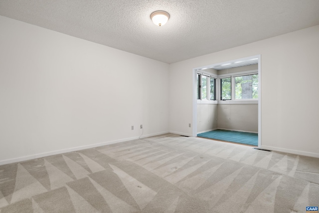 1184 Partridge Ln, Charlottesville, VA 22901 - spare room featuring a textured ceiling, carpet floors, and baseboards