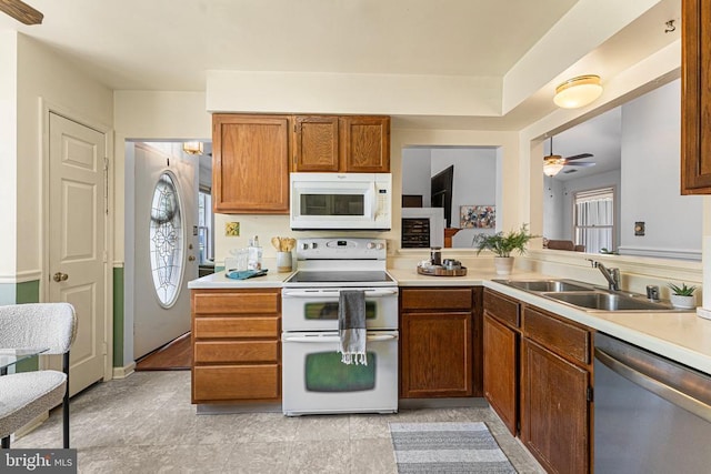 10630 Bent Tree Dr, Fredericksburg, VA 22407 - kitchen featuring brown cabinets, a ceiling fan, a sink, white appliances, and light countertops