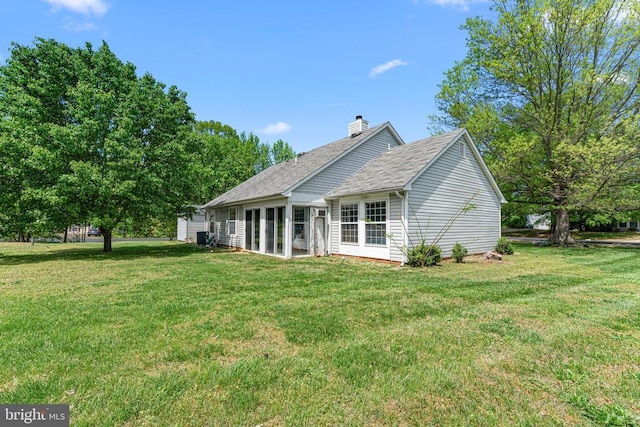 10630 Bent Tree Dr, Fredericksburg, VA 22407 - back of property with a yard, roof with shingles, a sunroom, and a chimney