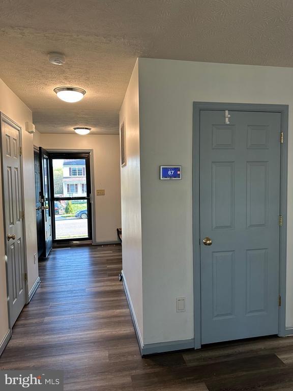 6015 Sunny Meadows Dr, Fredericksburg, VA 22407 - corridor with a textured ceiling, baseboards, and dark wood-style flooring