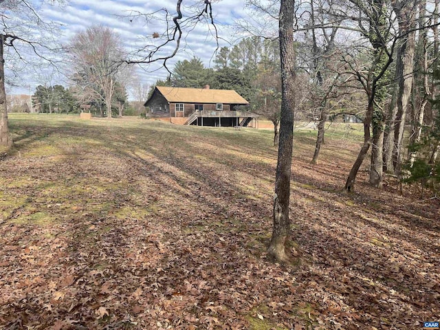 view of yard featuring stairway and a deck