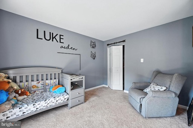  - carpeted bedroom featuring baseboards and a closet