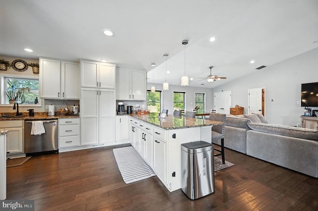  - kitchen with stainless steel dishwasher, open floor plan, a peninsula, dark wood-type flooring, and vaulted ceiling