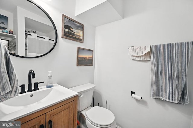  - bathroom featuring toilet and vanity