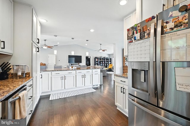  - kitchen with stainless steel appliances, a ceiling fan, open floor plan, a peninsula, and vaulted ceiling