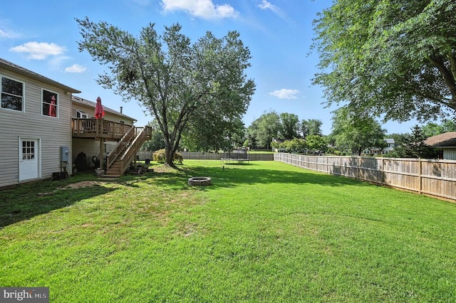  - fenced backyard with stairs, a wooden deck, and a fire pit