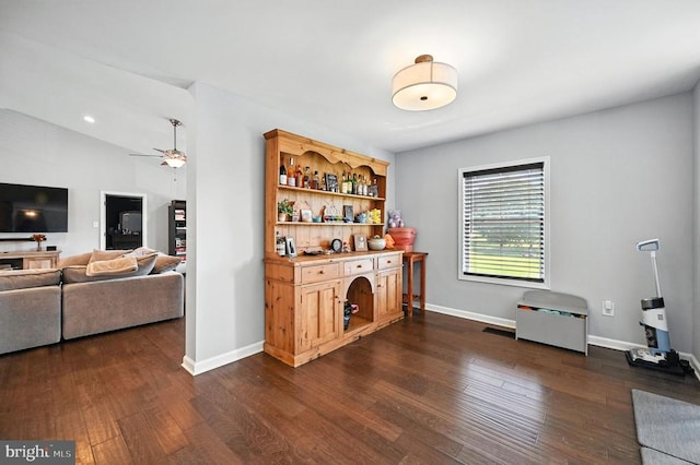  - bar with dark wood-style floors and a ceiling fan
