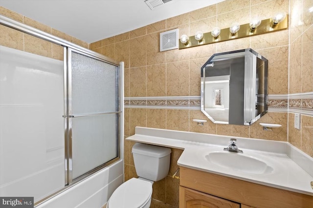 3714 Fairways Ct, Fredericksburg, VA 22408 - bathroom featuring tile walls, vanity, toilet, and combined bath / shower with glass door