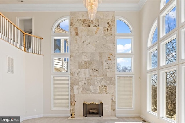 3714 Fairways Ct, Fredericksburg, VA 22408 - unfurnished living room featuring a high ceiling, ornamental molding, a chandelier, baseboards, and a fireplace