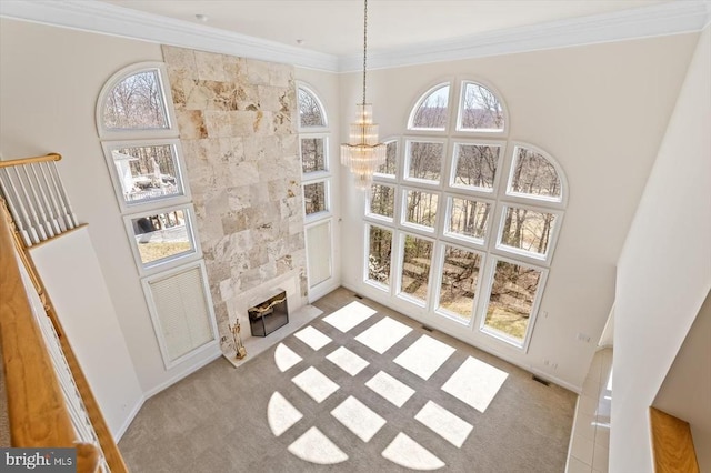 3714 Fairways Ct, Fredericksburg, VA 22408 - unfurnished living room with light carpet, crown molding, a tiled fireplace, and baseboards