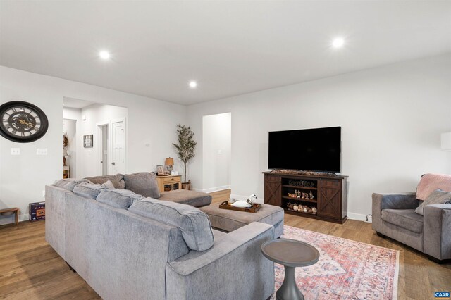 living room with wood finished floors, recessed lighting, and baseboards