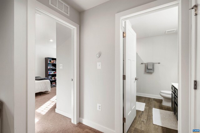 corridor with baseboards and carpet flooring