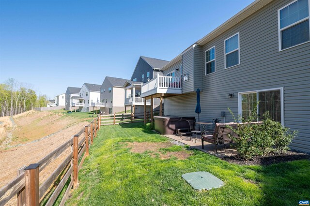 view of yard featuring a hot tub and a residential view
