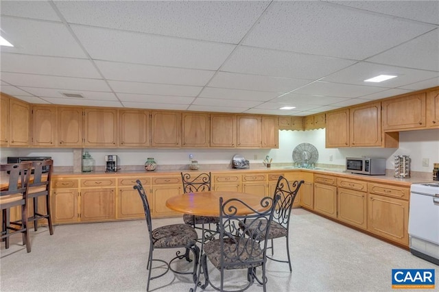 6904 James Madison Hwy, Fork Union, VA 23055 - kitchen featuring stainless steel microwave, range, visible vents, light countertops, and a drop ceiling