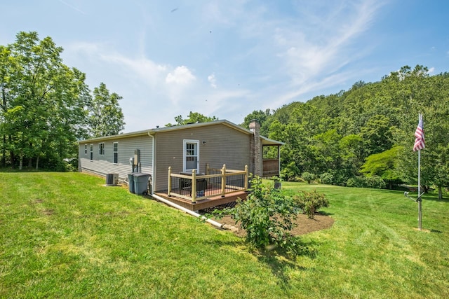 554 Harris Cove Ln, Elkton, VA 22827 - rear view of house featuring a wooden deck, a chimney, and a lawn