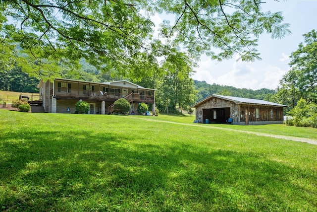 554 Harris Cove Ln, Elkton, VA 22827 - view of green lawn featuring a garage, a deck, and an outdoor structure