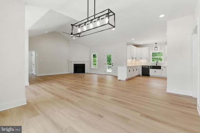 195 Promise Ln, Bumpass, VA 23024 - unfurnished living room with recessed lighting, a sink, vaulted ceiling, baseboards, and light wood finished floors