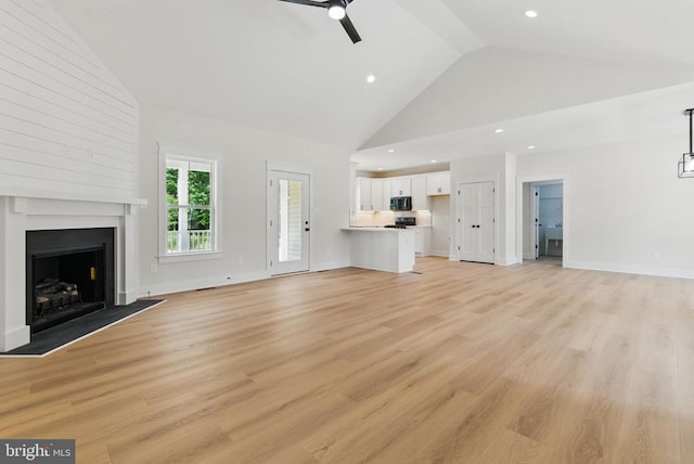 195 Promise Ln, Bumpass, VA 23024 - unfurnished living room featuring high vaulted ceiling, a ceiling fan, a fireplace, light wood finished floors, and recessed lighting