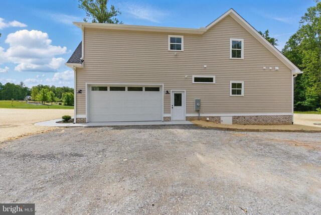 195 Promise Ln, Bumpass, VA 23024 - rear view of house with a garage and gravel driveway