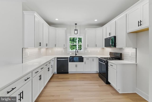 195 Promise Ln, Bumpass, VA 23024 - kitchen with black gas range oven, stainless steel microwave, dishwashing machine, a sink, and white cabinetry
