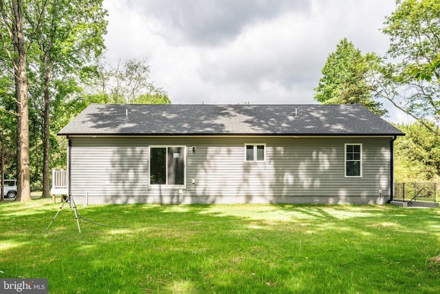 back of house with a lawn