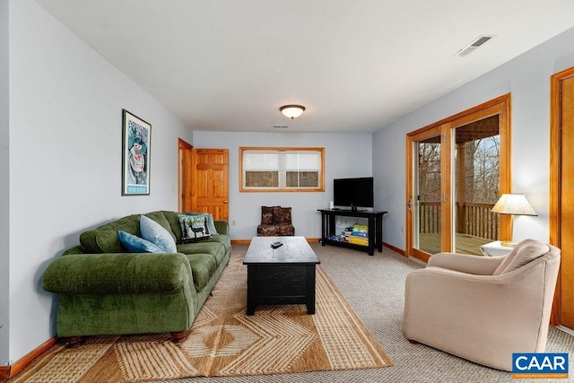 living room featuring carpet flooring, visible vents, and baseboards